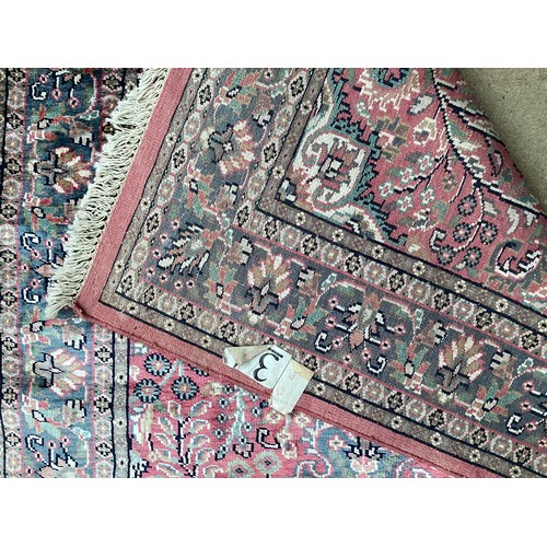 352 - A Kashmir silk rug with pink background and blue and pink border and floral pattern, 94cm x 156cm. G... 