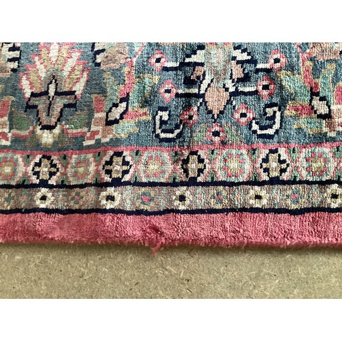 352 - A Kashmir silk rug with pink background and blue and pink border and floral pattern, 94cm x 156cm. G... 