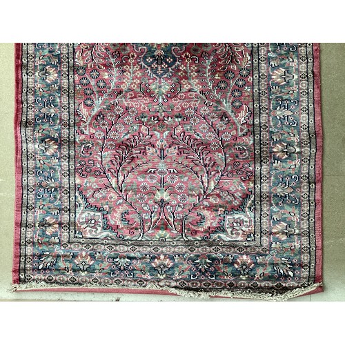 352 - A Kashmir silk rug with pink background and blue and pink border and floral pattern, 94cm x 156cm. G... 