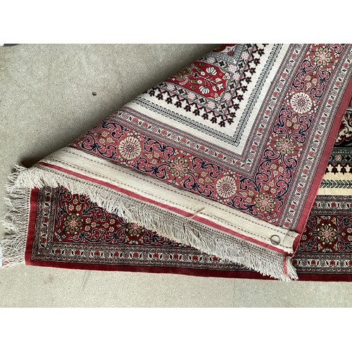 354 - Oriental handmade silk rug/prayer mat, central pattern with ornate border. Colours are mainly red, g... 