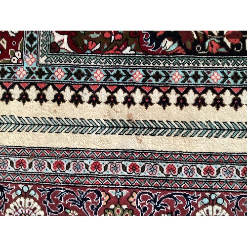 354 - Oriental handmade silk rug/prayer mat, central pattern with ornate border. Colours are mainly red, g... 