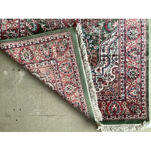 355 - Oriental handmade silk rug with central medallion and pattern borders. Overall colours green, cream ... 