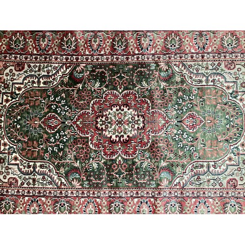 355 - Oriental handmade silk rug with central medallion and pattern borders. Overall colours green, cream ... 