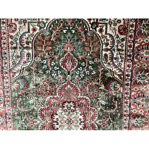 355 - Oriental handmade silk rug with central medallion and pattern borders. Overall colours green, cream ... 