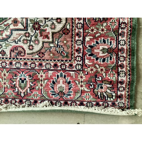 355 - Oriental handmade silk rug with central medallion and pattern borders. Overall colours green, cream ... 