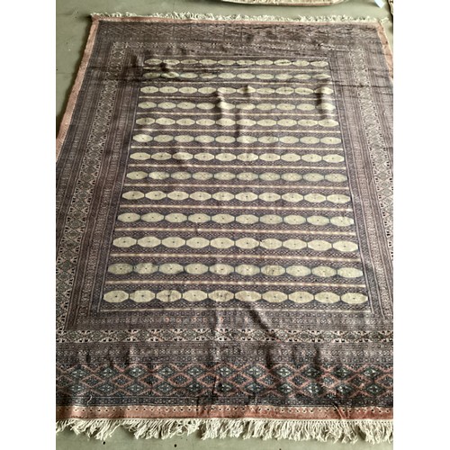 359 - Large Persian style rug with geometric central pattern and borders, main colours are pink and blues,... 