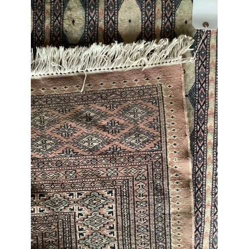 359 - Large Persian style rug with geometric central pattern and borders, main colours are pink and blues,... 