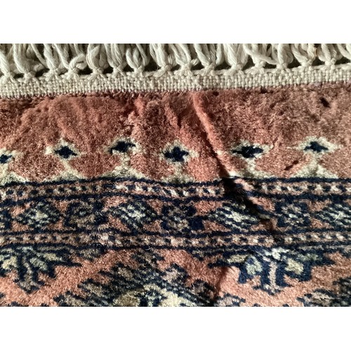 359 - Large Persian style rug with geometric central pattern and borders, main colours are pink and blues,... 