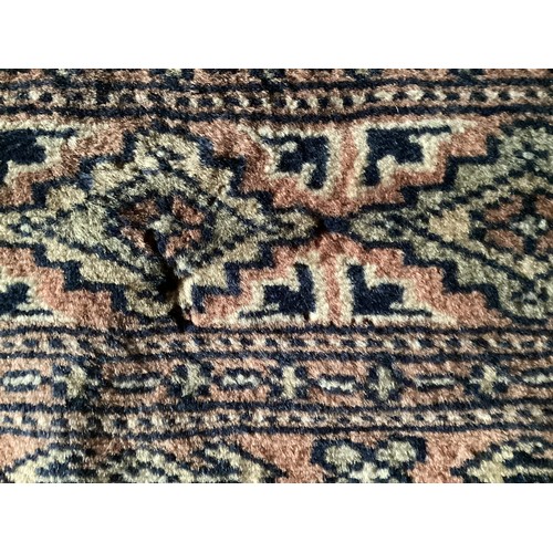 359 - Large Persian style rug with geometric central pattern and borders, main colours are pink and blues,... 