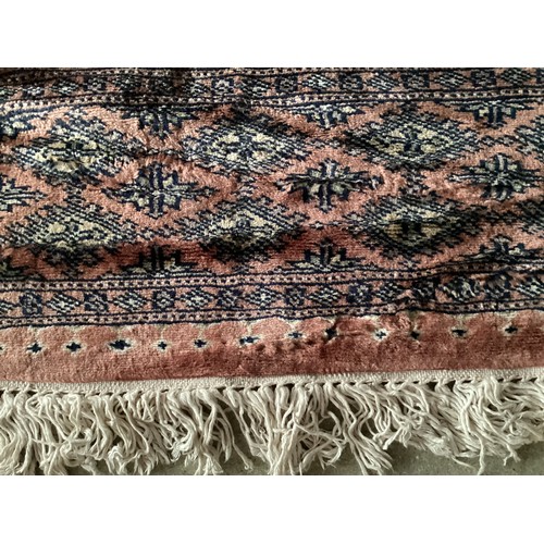 359 - Large Persian style rug with geometric central pattern and borders, main colours are pink and blues,... 