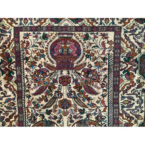 360 - Persian rug, central pattern of flower vases and weeping women and ornate borders with birds. Colour... 