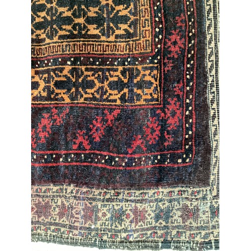 363 - Wool handmade rug with central pattern and borders and reverse stitched outer border. Main colours a... 