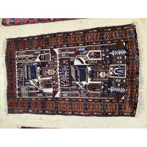 365 - Wool handmade rug, depicting temples and border. Main colours are brown, cream blues, 80-82cm x 131.... 