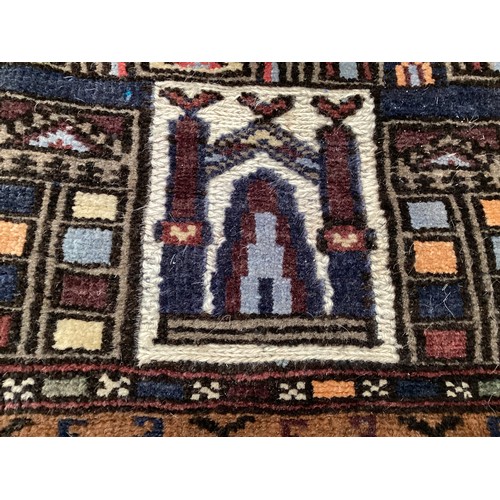 365 - Wool handmade rug, depicting temples and border. Main colours are brown, cream blues, 80-82cm x 131.... 