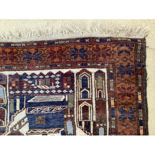 365 - Wool handmade rug, depicting temples and border. Main colours are brown, cream blues, 80-82cm x 131.... 