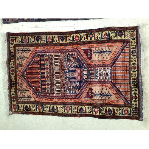 366 - Wool handmade rug with central pattern depicting a temple and border. Main colours are brown, orange... 