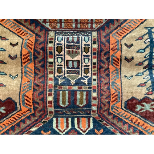 366 - Wool handmade rug with central pattern depicting a temple and border. Main colours are brown, orange... 