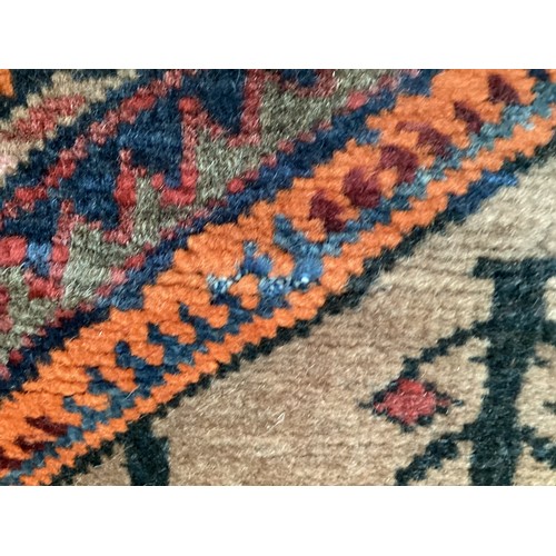 366 - Wool handmade rug with central pattern depicting a temple and border. Main colours are brown, orange... 