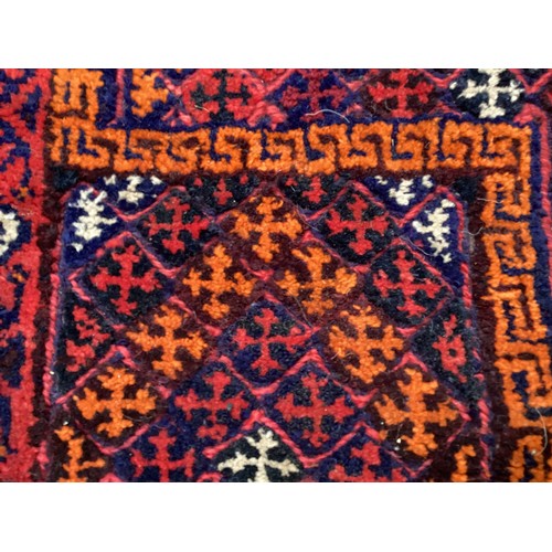 368 - Oriental wool handmade rug with embossed central design and a border. Main colours are red, blue and... 