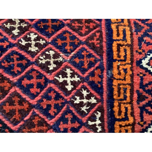 368 - Oriental wool handmade rug with embossed central design and a border. Main colours are red, blue and... 