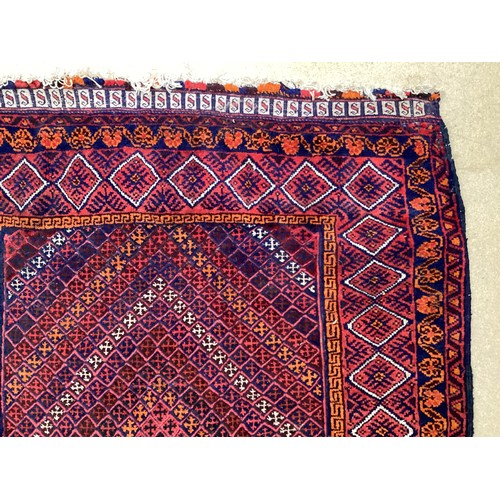 368 - Oriental wool handmade rug with embossed central design and a border. Main colours are red, blue and... 