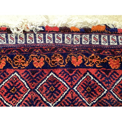 368 - Oriental wool handmade rug with embossed central design and a border. Main colours are red, blue and... 