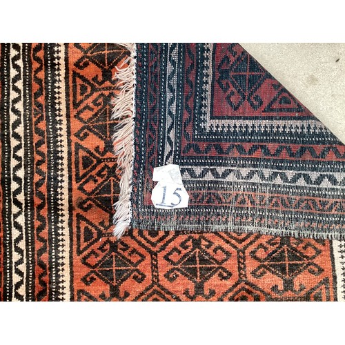 369 - Wool handmade rug with central pattern and border. Main colours are orange and brown. Condition- few... 