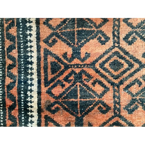 369 - Wool handmade rug with central pattern and border. Main colours are orange and brown. Condition- few... 