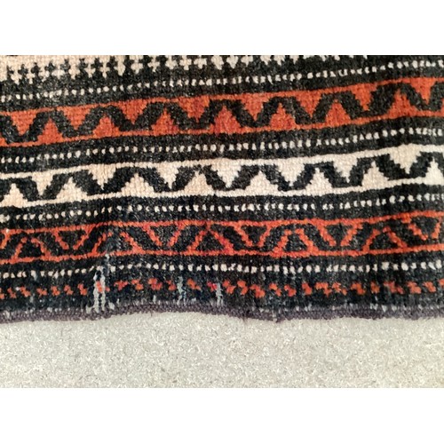 369 - Wool handmade rug with central pattern and border. Main colours are orange and brown. Condition- few... 