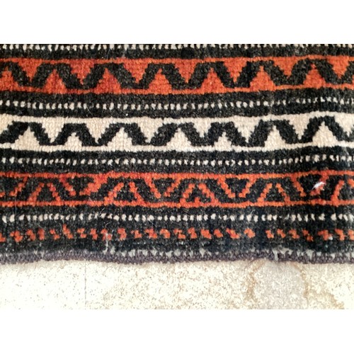 369 - Wool handmade rug with central pattern and border. Main colours are orange and brown. Condition- few... 