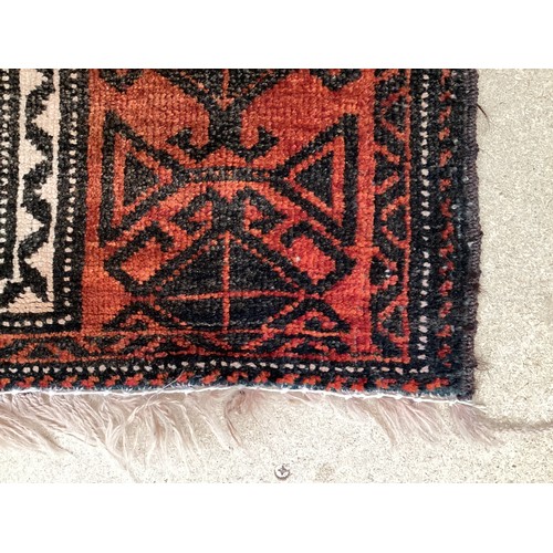 369 - Wool handmade rug with central pattern and border. Main colours are orange and brown. Condition- few... 