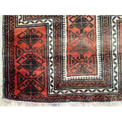 369 - Wool handmade rug with central pattern and border. Main colours are orange and brown. Condition- few... 