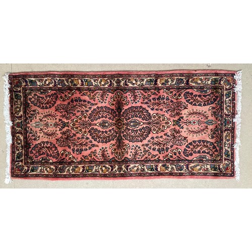 370 - Oriental wool rug with central pattern and border, pink background with blues, cream and yellow. Gen... 