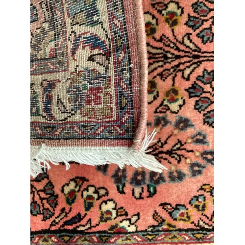 370 - Oriental wool rug with central pattern and border, pink background with blues, cream and yellow. Gen... 