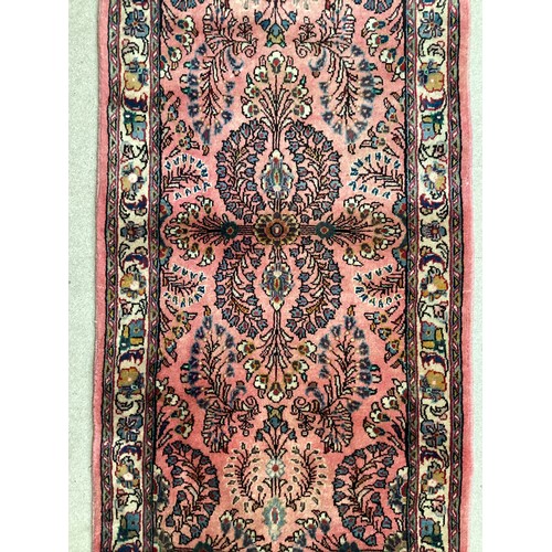 370 - Oriental wool rug with central pattern and border, pink background with blues, cream and yellow. Gen... 