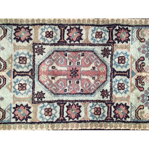 370 - Oriental wool rug with central pattern and border, pink background with blues, cream and yellow. Gen... 