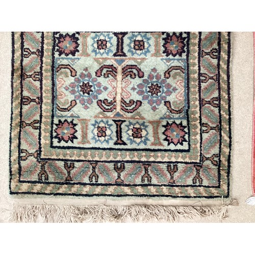 370 - Oriental wool rug with central pattern and border, pink background with blues, cream and yellow. Gen... 