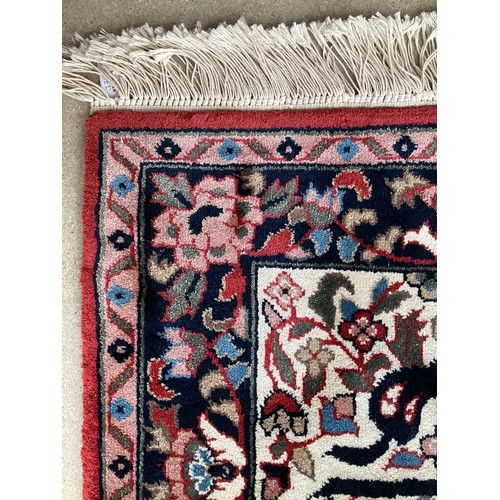 371 - Two similar small wool ? handmade oriental rugs , with central pattern of hieroglyphics symbols and ... 