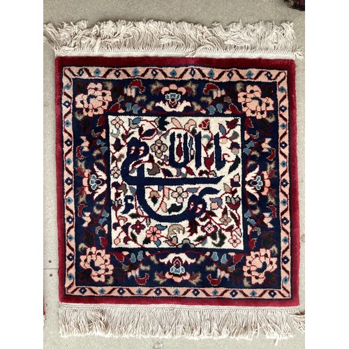 371 - Two similar small wool ? handmade oriental rugs , with central pattern of hieroglyphics symbols and ... 