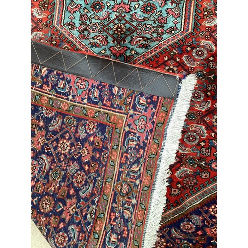 374 - A Persian style red ground rug, see photos for details.  Condition good.  116 cm x 170 cm