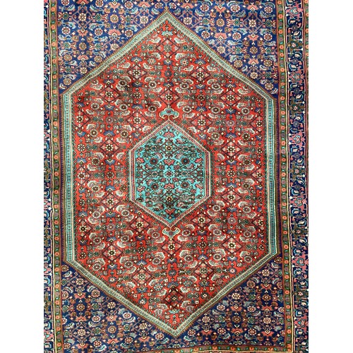 374 - A Persian style red ground rug, see photos for details.  Condition good.  116 cm x 170 cm