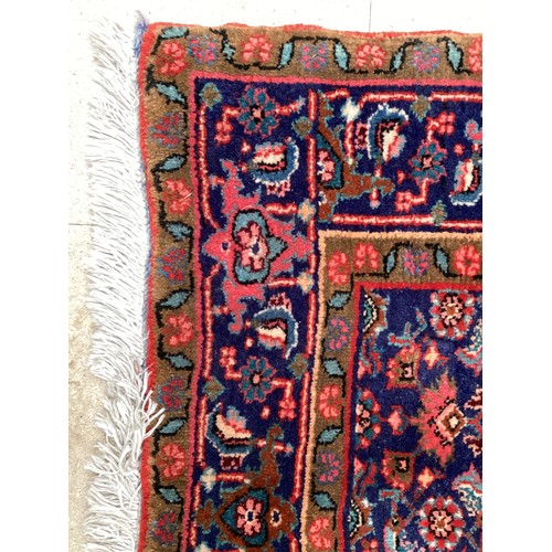 374 - A Persian style red ground rug, see photos for details.  Condition good.  116 cm x 170 cm