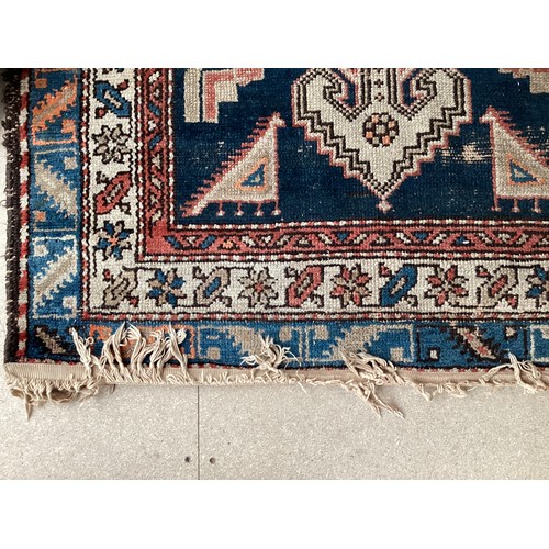 377 - Three small rugs, see photos for details, much wear to edges and all over wear commensurate with use... 