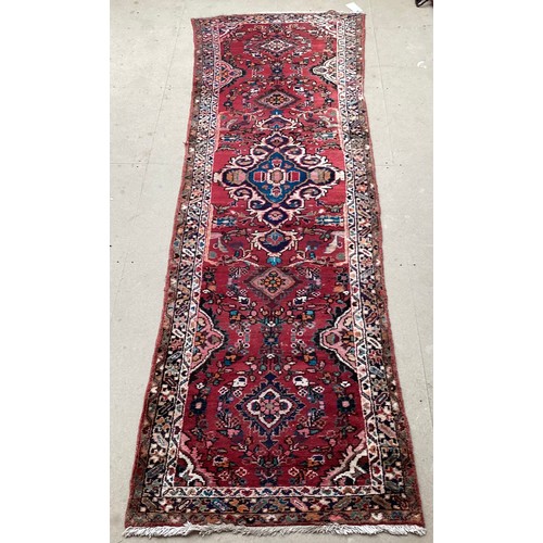 378 - Red ground runner, see photos for details, 96 cm x 297 cm, condition all over wear.