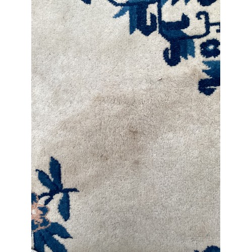 382 - An Oriental rug with cream ground and blue geometric patterns see photos for details, good condition... 