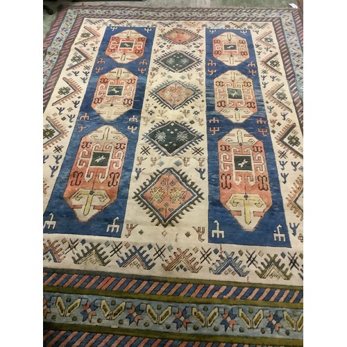 348 - large wool rug, 256cm x 340cm. In fair condition, a few stains, loss of pile, damage to the fringe