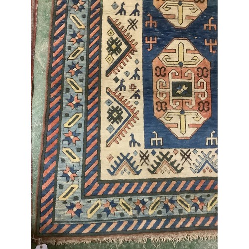 348 - large wool rug, 256cm x 340cm. In fair condition, a few stains, loss of pile, damage to the fringe