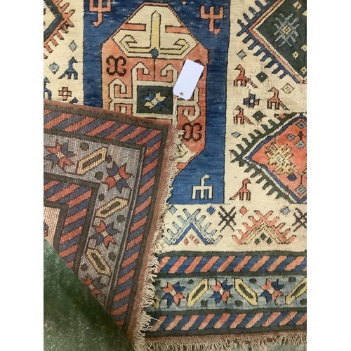 348 - large wool rug, 256cm x 340cm. In fair condition, a few stains, loss of pile, damage to the fringe