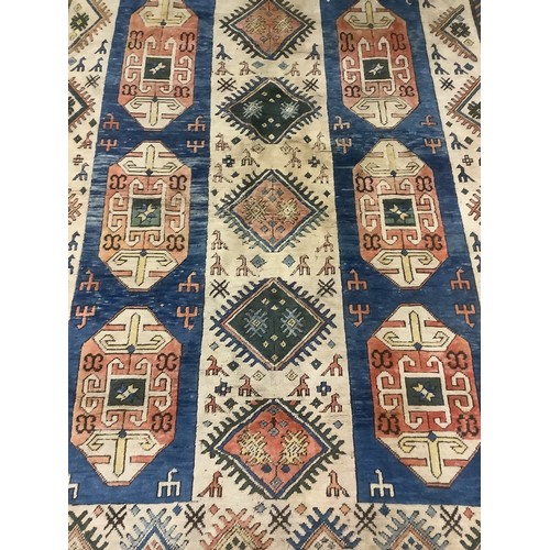 348 - large wool rug, 256cm x 340cm. In fair condition, a few stains, loss of pile, damage to the fringe