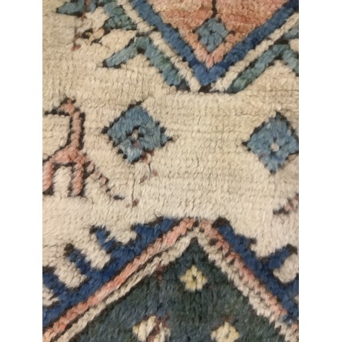 348 - large wool rug, 256cm x 340cm. In fair condition, a few stains, loss of pile, damage to the fringe